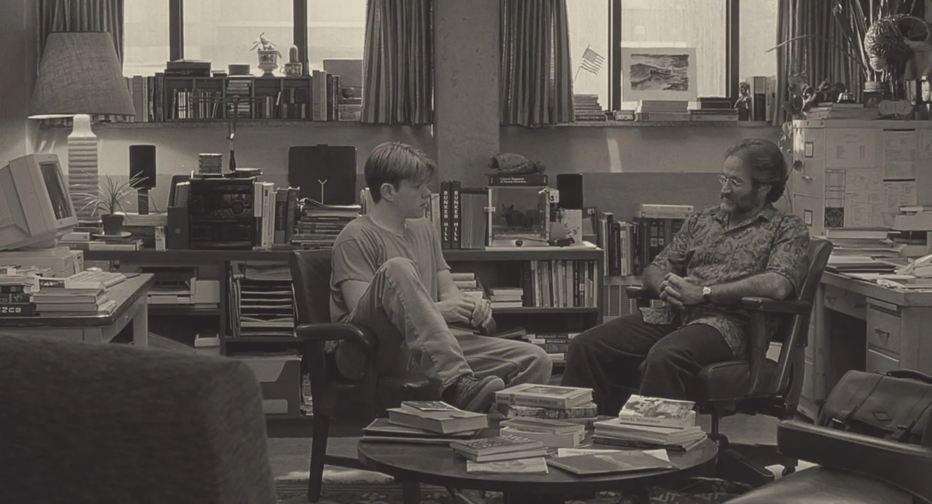 Will and Sean sit across from each other, mid-session, in Sean's book-lined office in Good Will Hunting